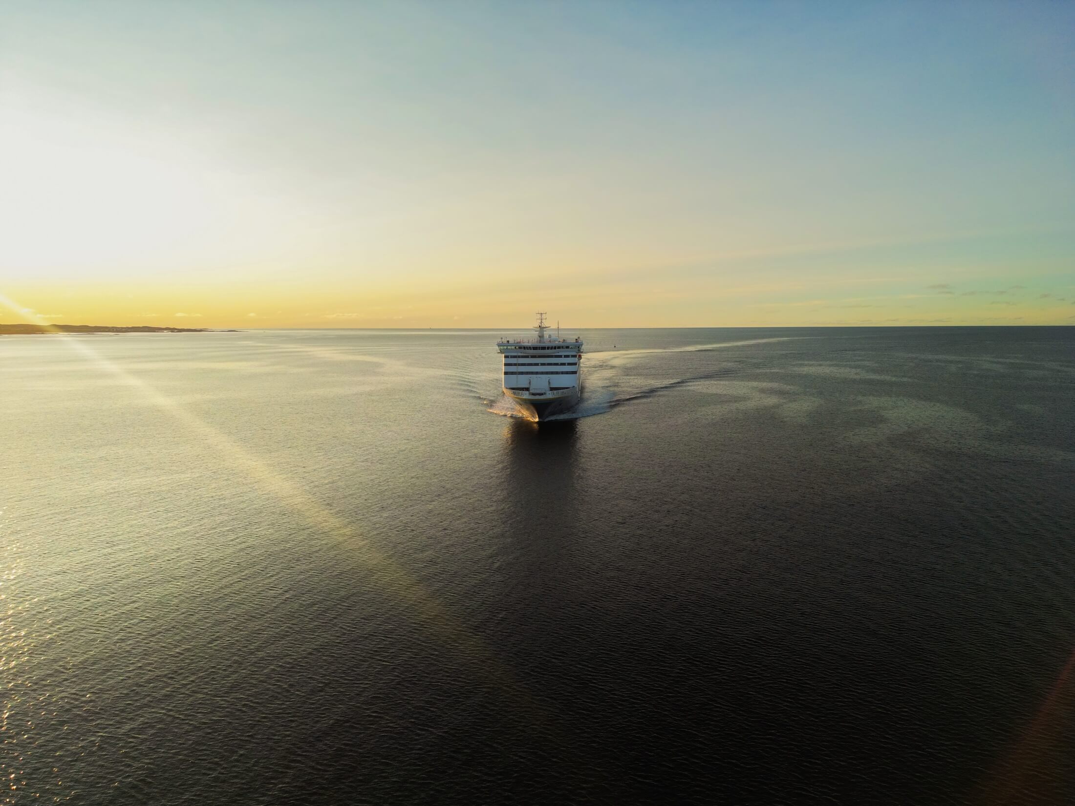 vessel sailing in sunset