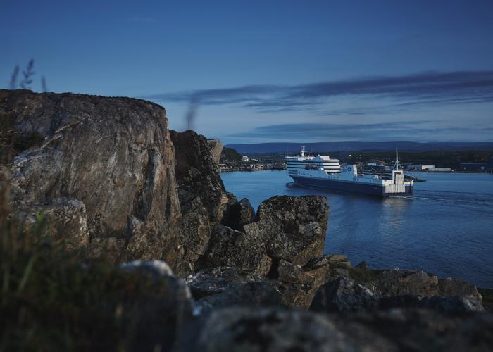 A Marine Atlantic ferry sails past the rocky granite coastline into the harbour at Port aux Basques,  Newfoundland.