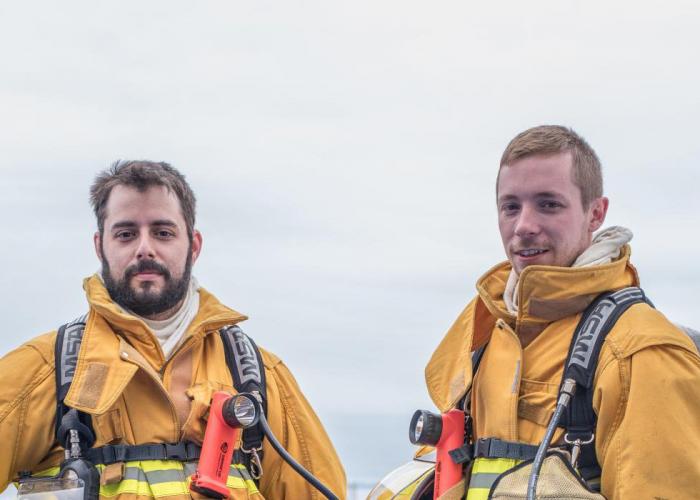 Two firefighters standing outside