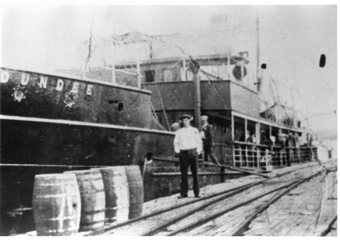 A man standing in front of the SS Dundee