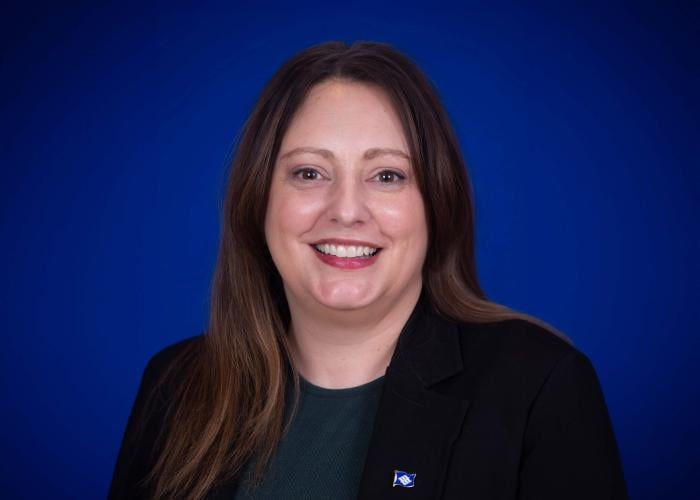 A photo of a woman in front of a blue background