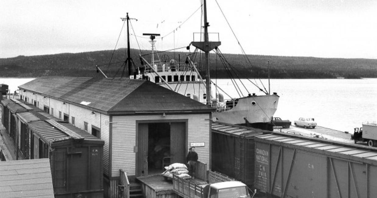 Nonia docked next to a small building