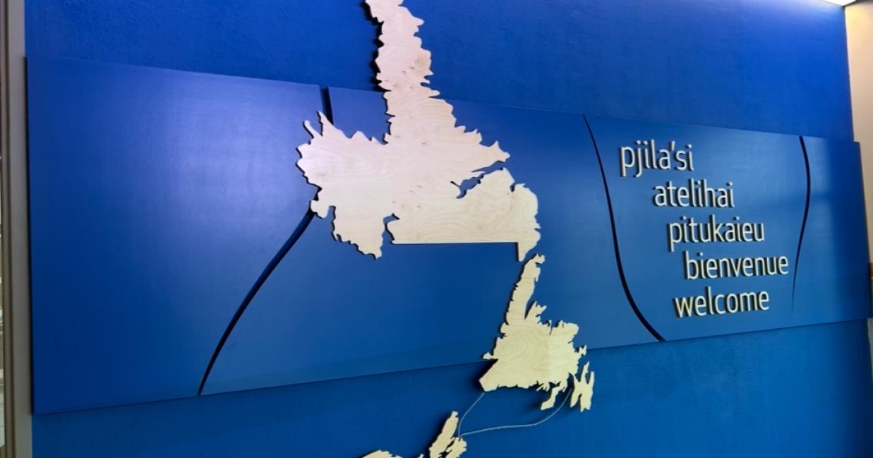 Map of Newfoundland and Labrador and Nova Scotia with welcome greetings in Indigenous languages, French, and English.