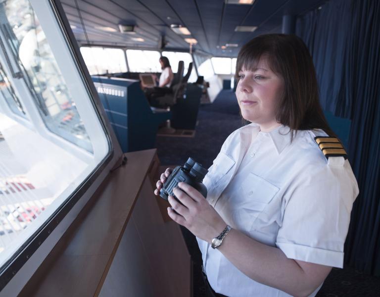 A crew member with binoculars