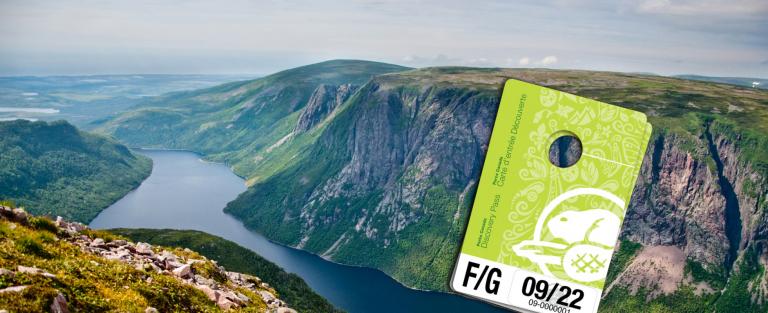 Beautiful Newfoundland fjords with a Parks Canada pass in the foreground.