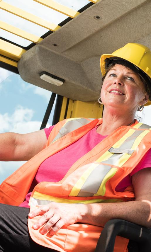 Woman sitting at the steering wheel.