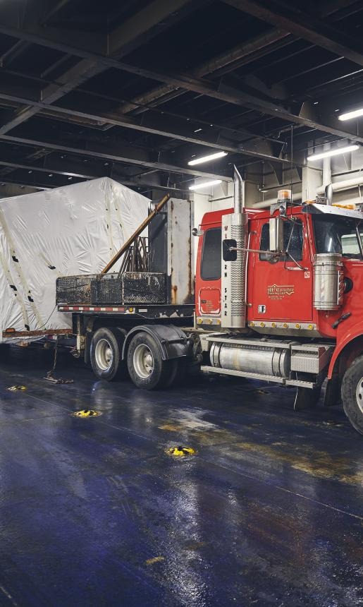 Truck carrying small home on its trailer.