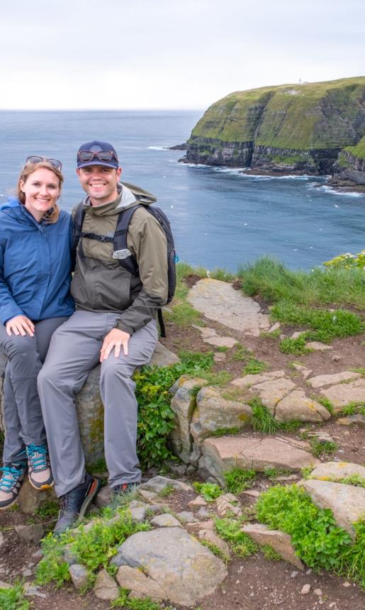 A couple sitting by the coast of Newfoundland