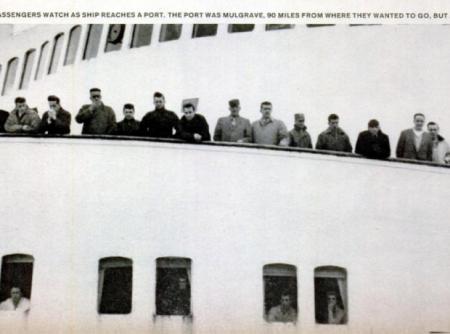 Passengers watch as ship reaches port